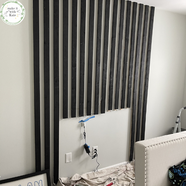 This bedroom light wall uses an accent slat wall wrapped with led lights to create a fun accent wall sure to please anyone. #accentwall #lightwall #ledlightwall #teenbedroom #bedroommakeover