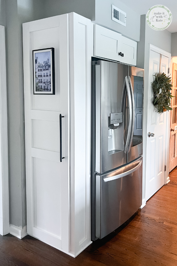 This refrigerator surround cabinet makes this kitchen fridge look built-in, plus it serves as a family command center.